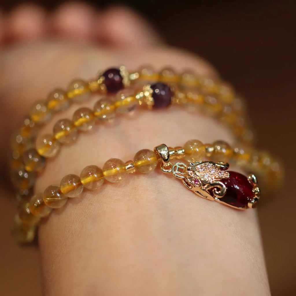 Natural Brazil gold rutilated quartz bracelet with three circular accents and Chinese-style hanging chopsticks design