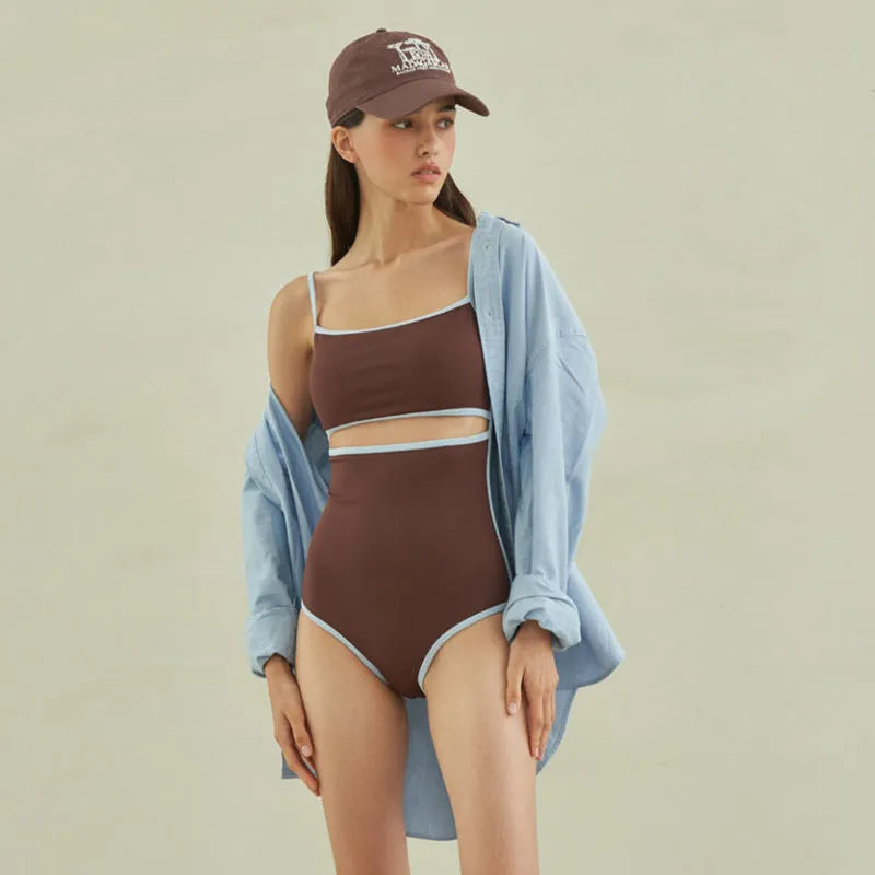 Brown one-piece swimsuit for women on a mannequin, showing the front design.