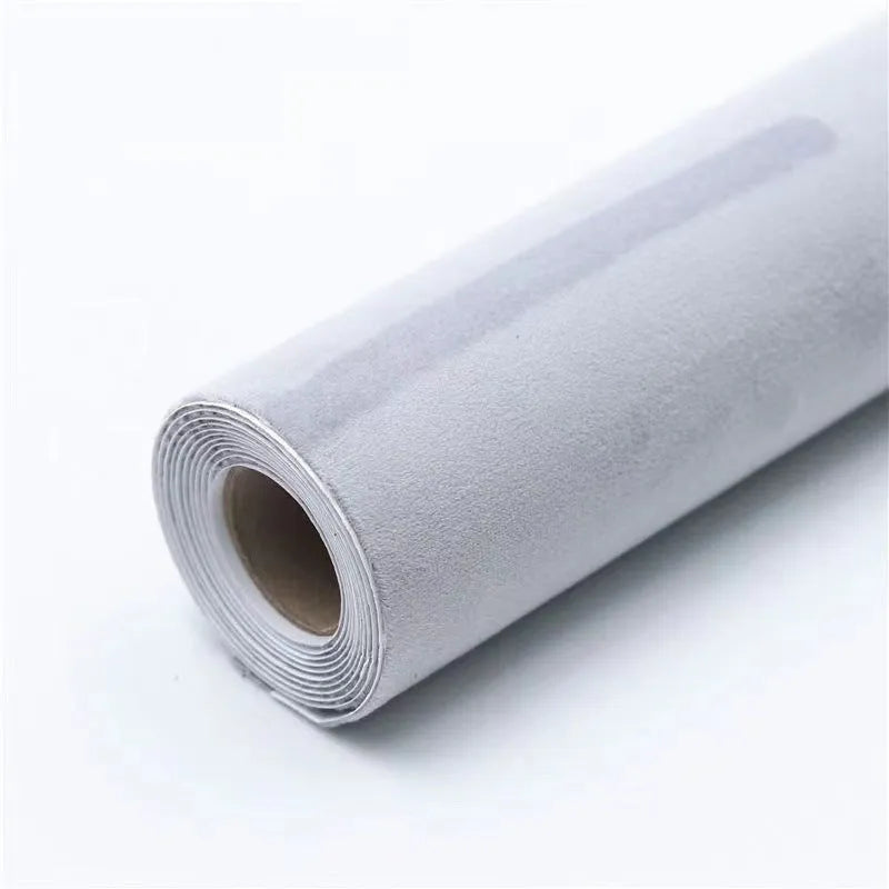 Roll of self-adhesive leather suede fabric in BMW brown colour next to a car dashboard.