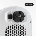 White plastic ceramic heating electric blower heater with remote control on a table.
