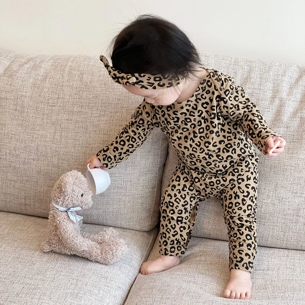 Brown leopard print cotton long-sleeved baby jumpsuit with matching headband, neutral unisex style