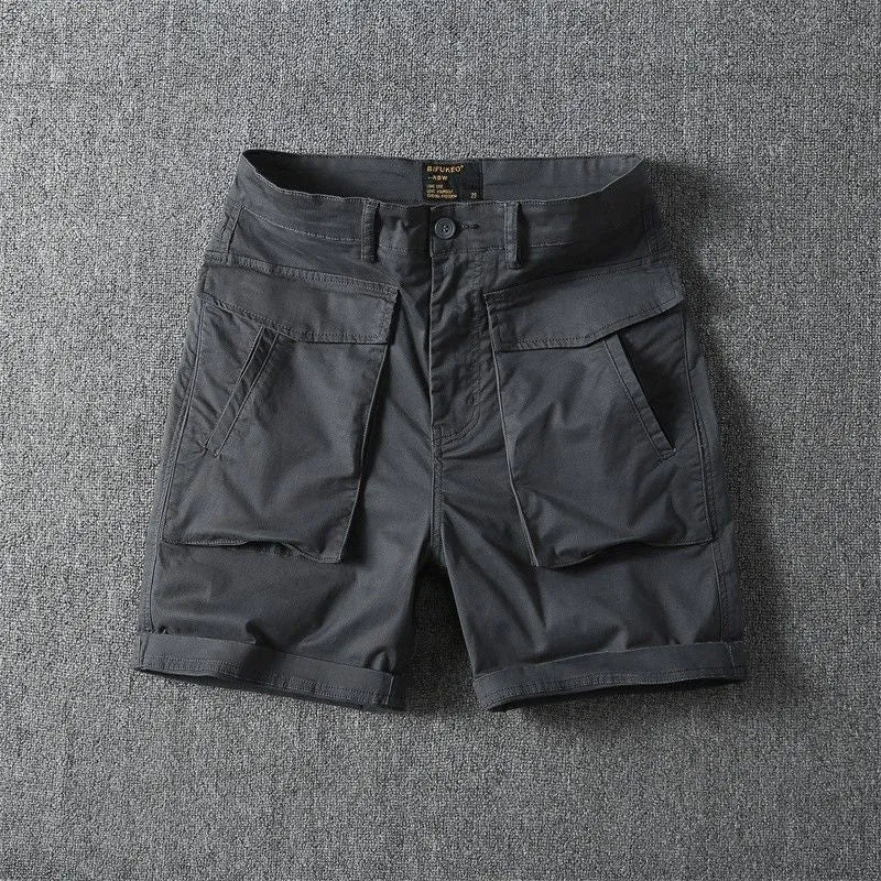 Men's straight-leg cotton cargo shorts in khaki with multiple pockets, shown on a model.