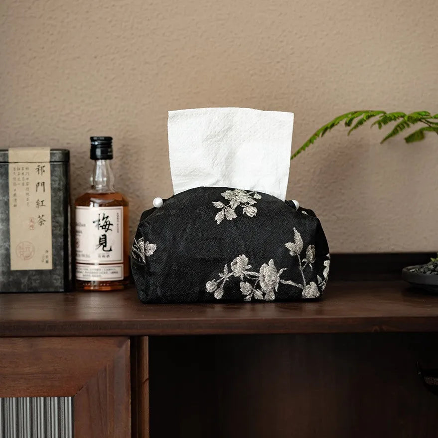 White embroidered plum blossom brocade tissue box cover with pearl buckle on table