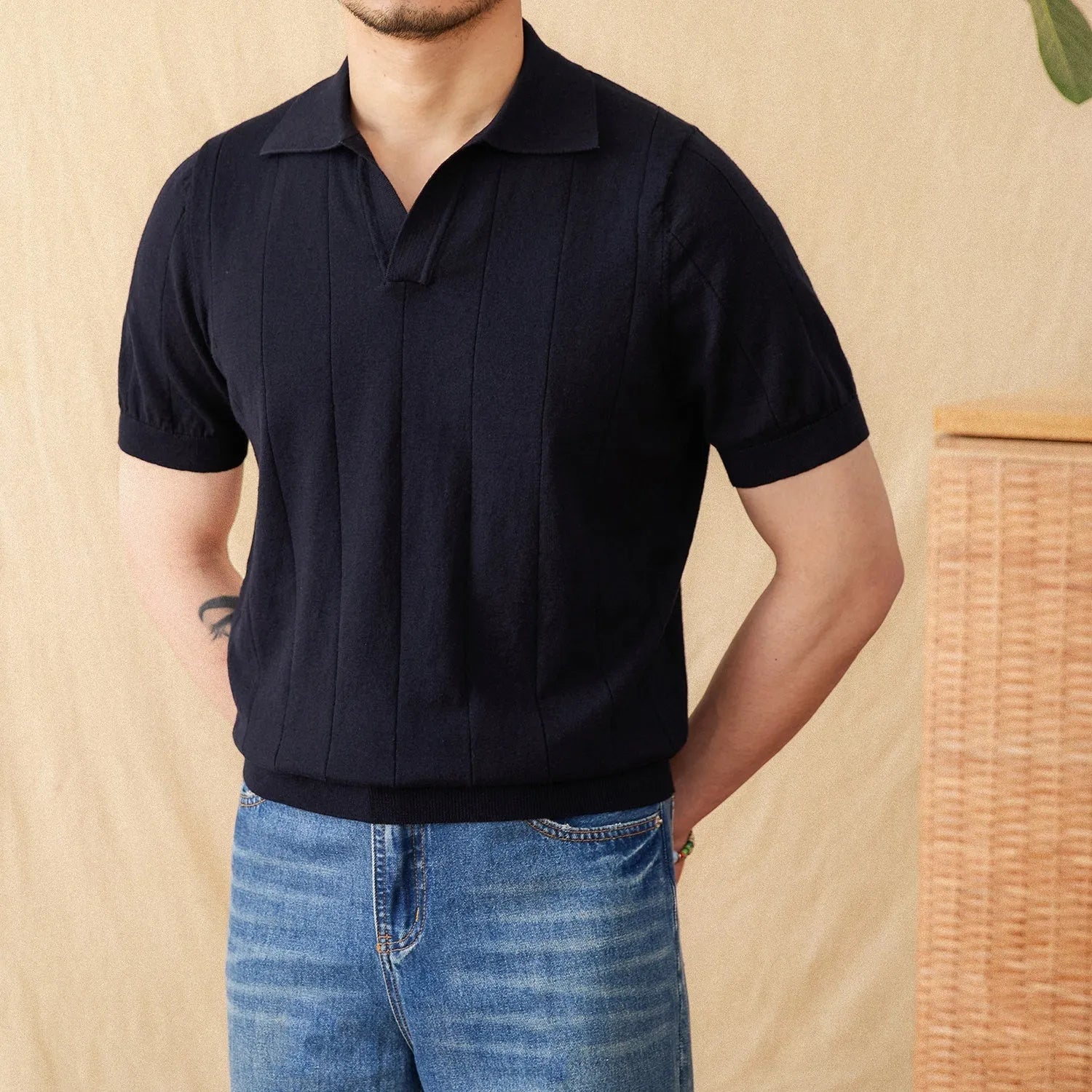 Men's purple short sleeve polo top with a knitted sunken stripe pattern and a classic collar.