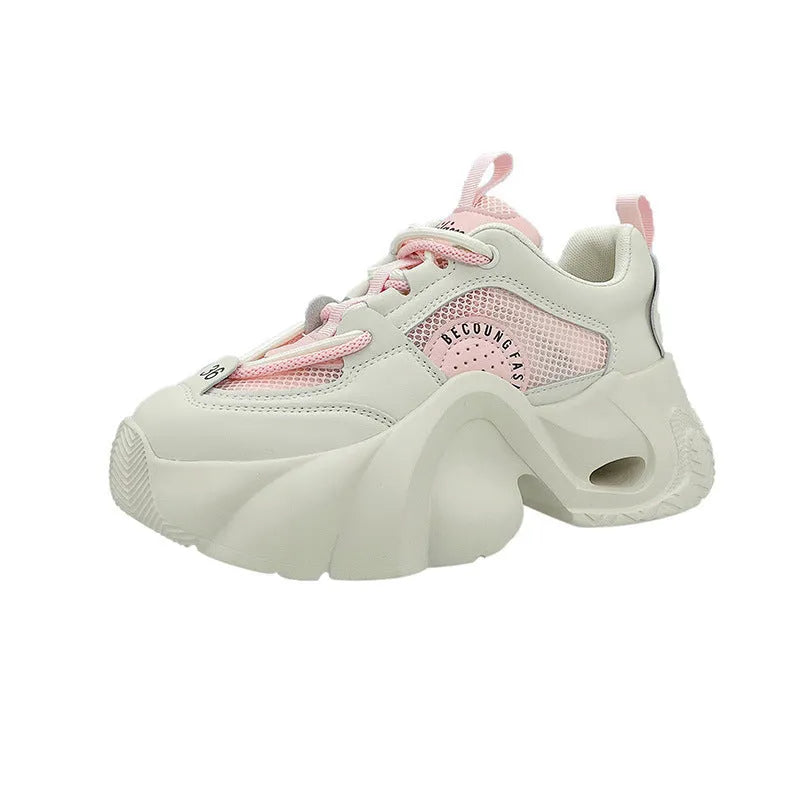 Women's beige sneakers with a thick sole, cross shoulder straps, and a mid heel.