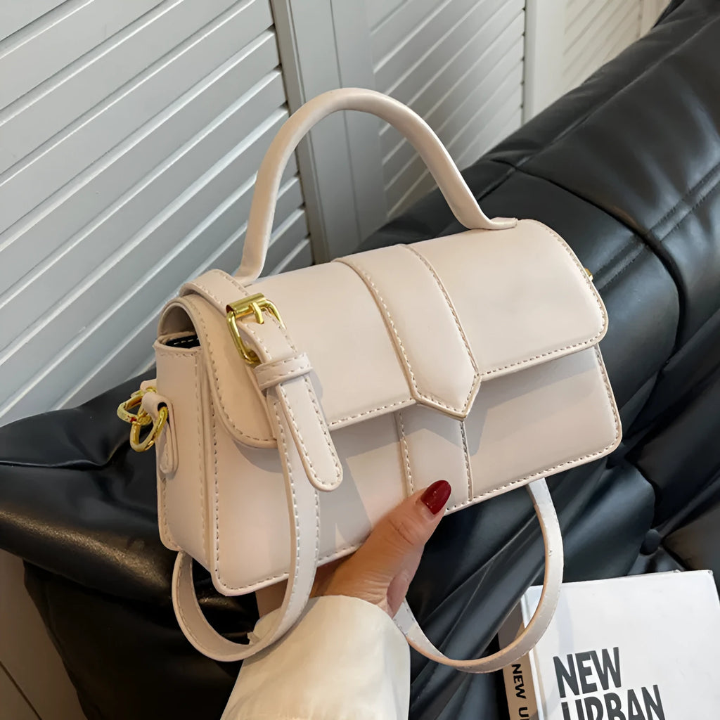 Beige women's horizontal square messenger bag with sandwich pocket and file organiser interior.
