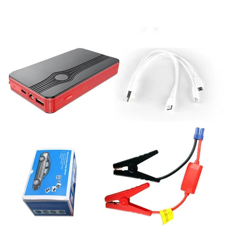 Red K4-E portable car jump starter and power bank unit with USB cable on a table.