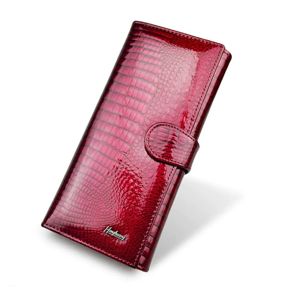 Women's red crocodile pattern patent leather coin purse with pigskin lining.