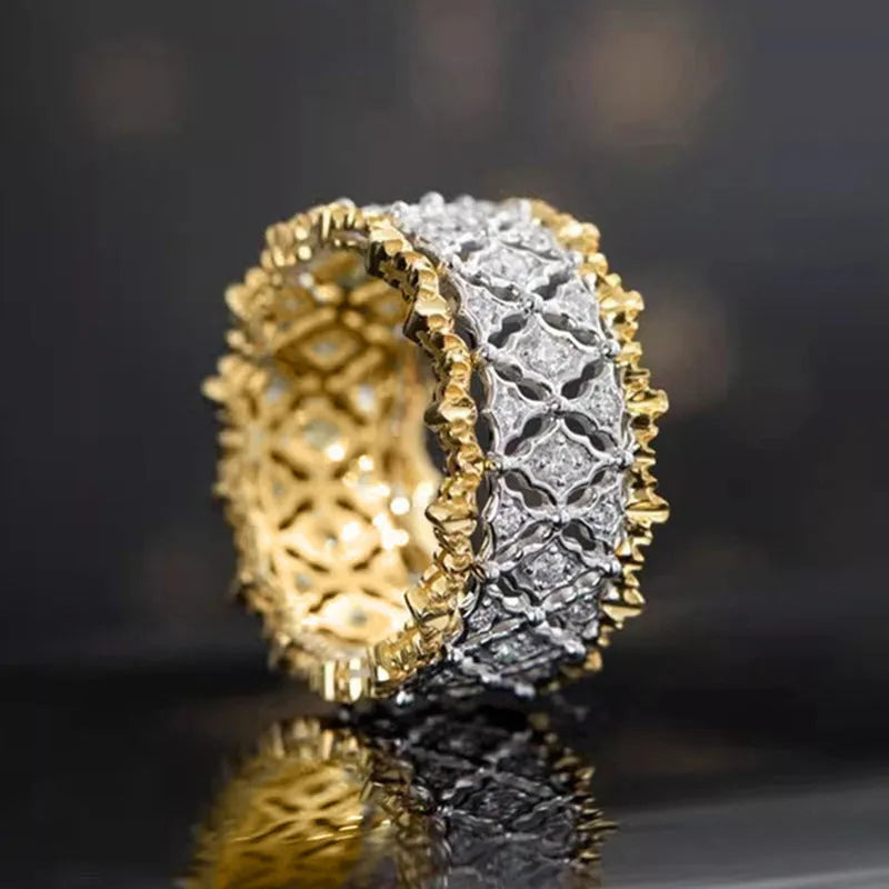 Geometric two-tone gold zircon ring with a round stone on a copper band.