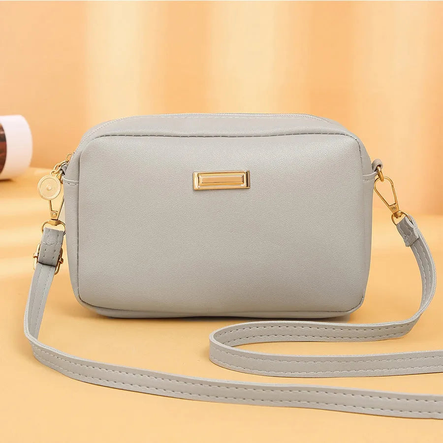 Solid colour minimalist ladies shoulder bag in PU leather with a three-dimensional pocket