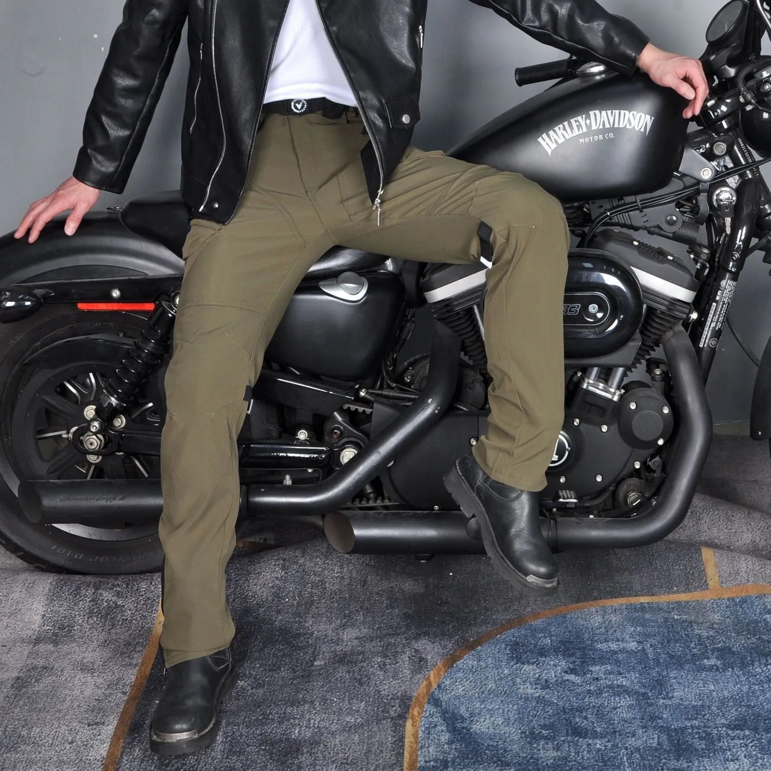 Men's black and green waterproof motorcycle cycling trousers with belt and protective gear.