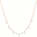 Women's silver necklace with a drop-shaped zircon pendant on an O-shaped chain, shown in golden yellow.
