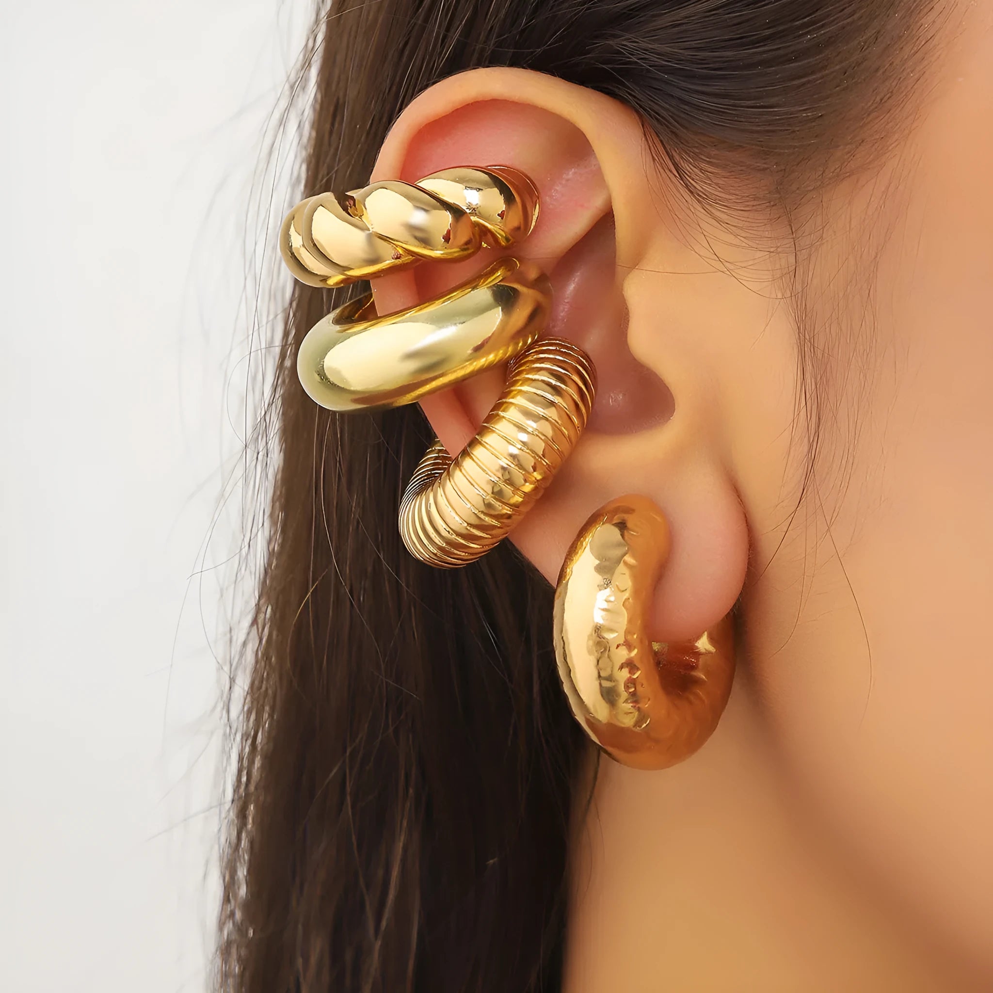 Set of four geometric clip-on earrings for women in gold and silver finishes.