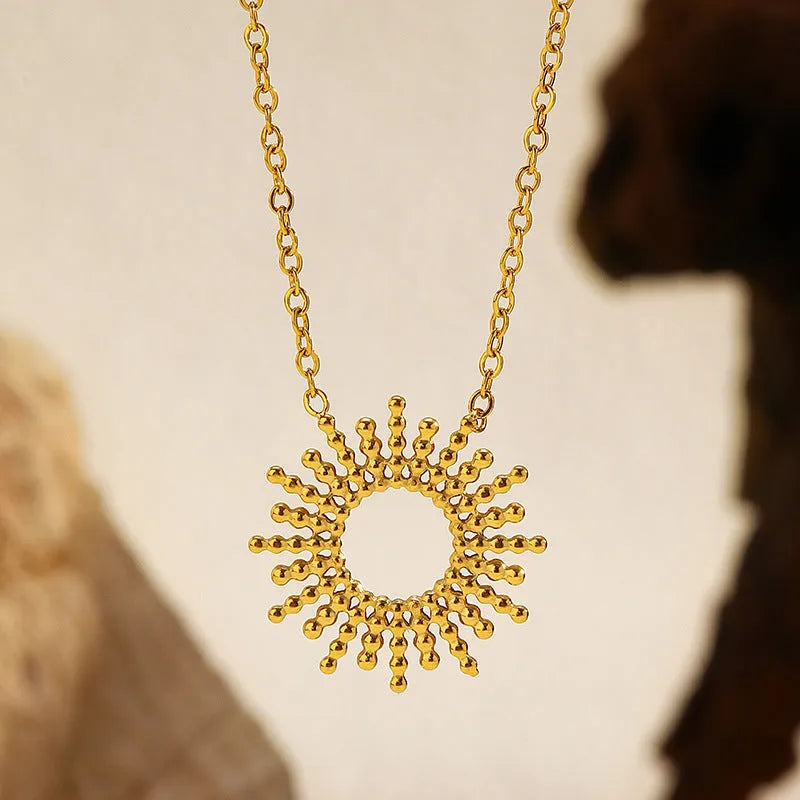 Gold-coloured SUNFLOWER Series necklace and bracelet set with chain links on a white background.