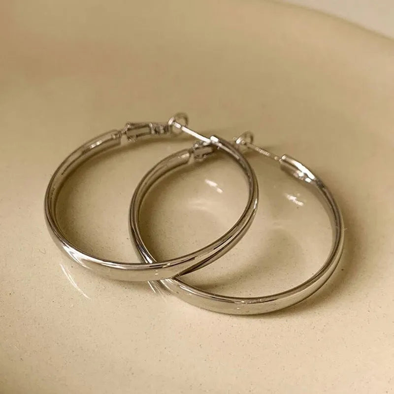 Circular metal earrings with gold finish showing 40mm diameter ring design