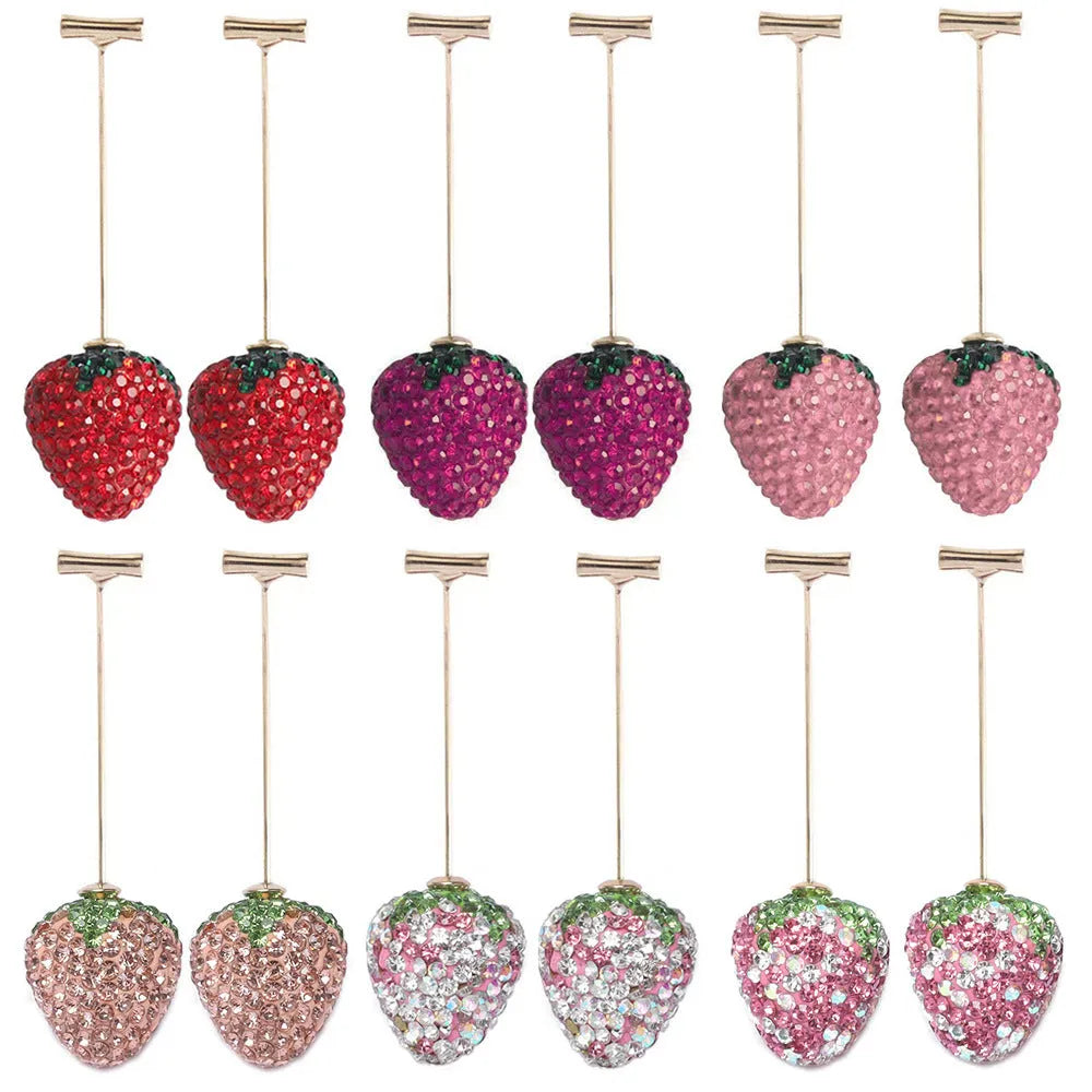 A pair of red geometric strawberry stud earrings with a faceted surface and butterfly clutch fastenings.