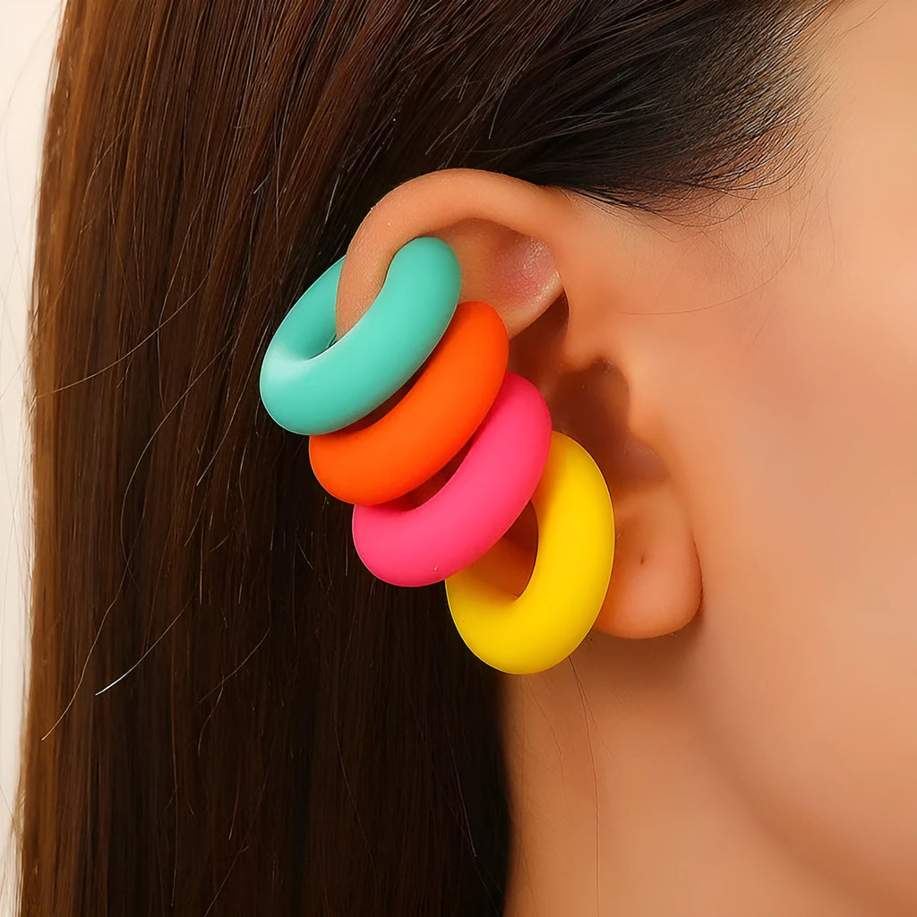 Round C-shaped clip-on earring with a matte coarse surface in a selection of candy colours.