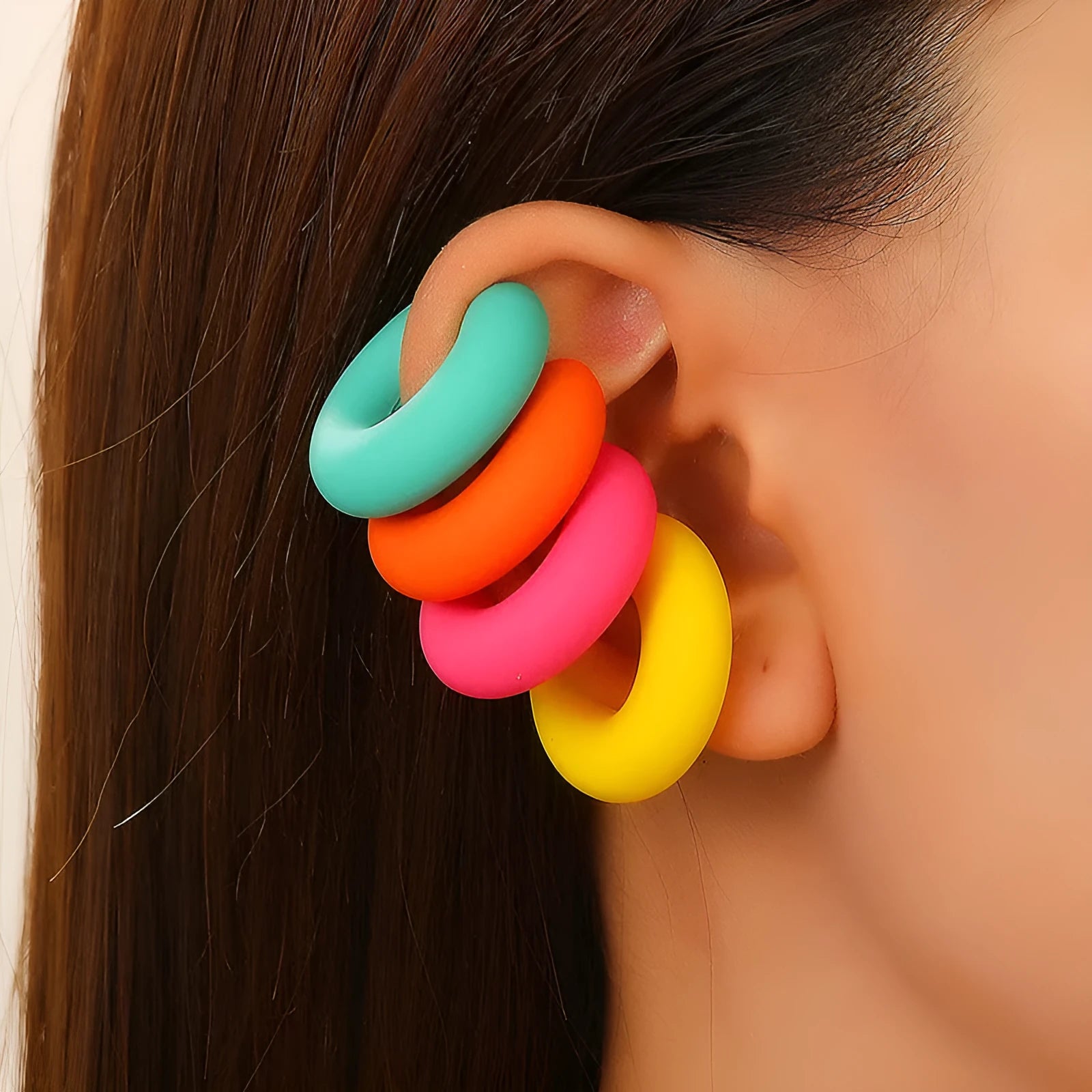 Round C-shaped clip-on earring with a matte coarse surface in a selection of candy colours.