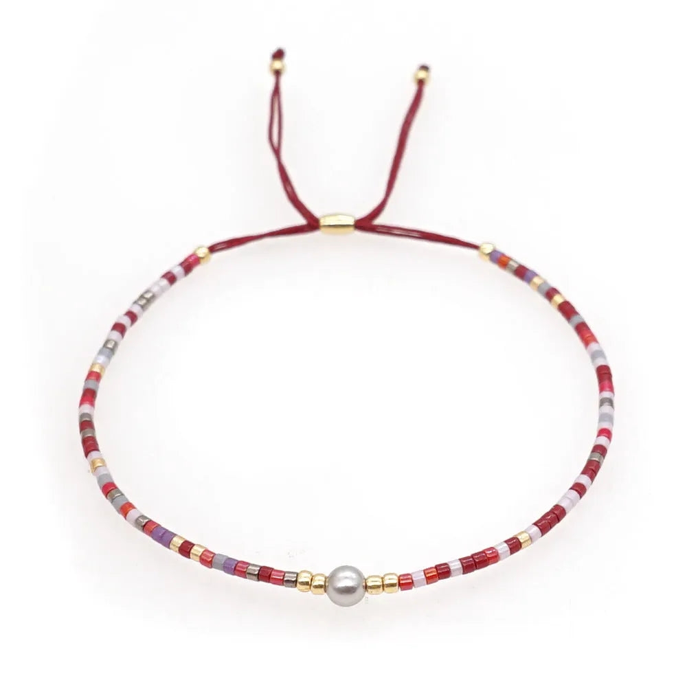 Handmade adjustable women's bracelet with colourful geometric glass and semi-precious stone beads in Bohemian style.