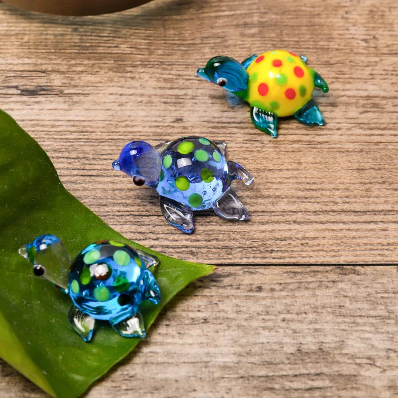 Modern geometric glass turtle ornament on a desk in blue head and blue shell colour variation.