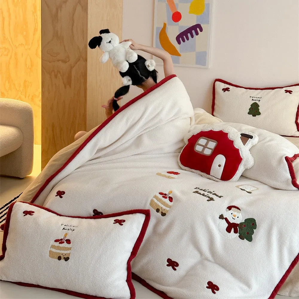 Cartoon pattern winter bedding four-piece set including bed sheet, duvet cover, and pillowcases on a bed.