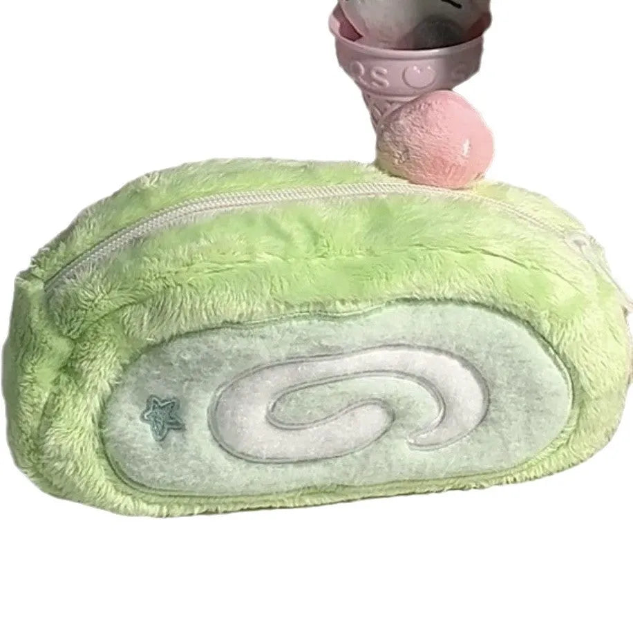 Honeydew green velvet pencil case with Swiss roll cake design, shown rolled up.