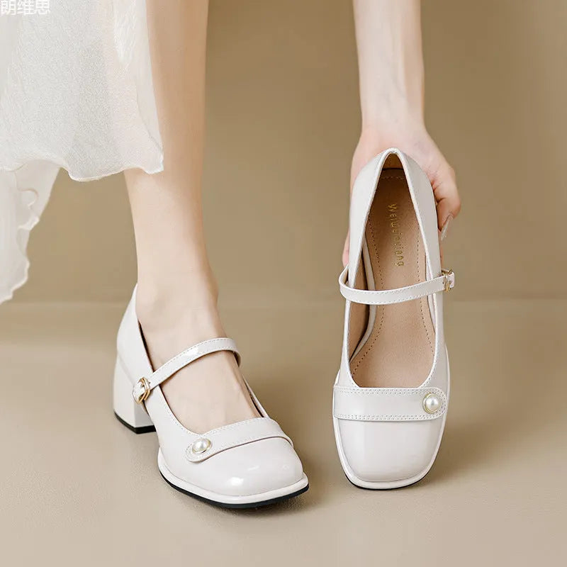 Women's apricot patent leather ankle boots with a chunky heel and ankle buckle.