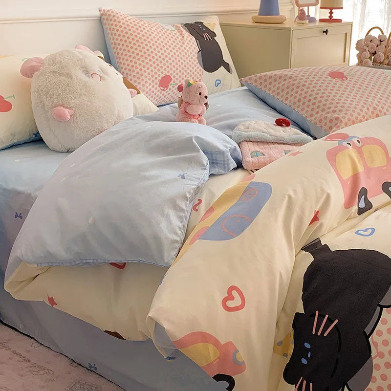 Cartoon dog pattern pure cotton duvet cover set with matching fitted sheet and pillowcases on a bed.