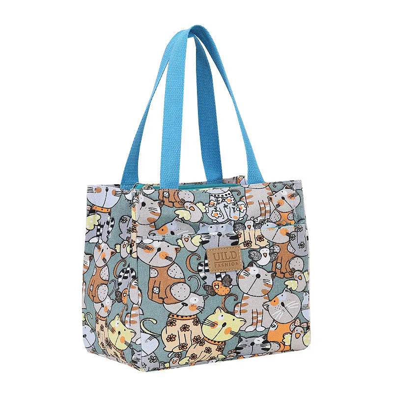 Women's large square canvas handbag with aluminium handles in a choice of printed floral and cat designs.