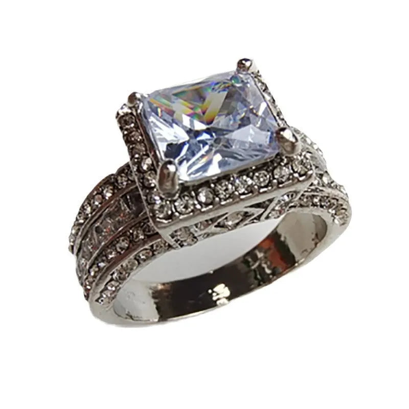 Geometric silver fashion ring for women in gold or white finish on a ring size mandrel.