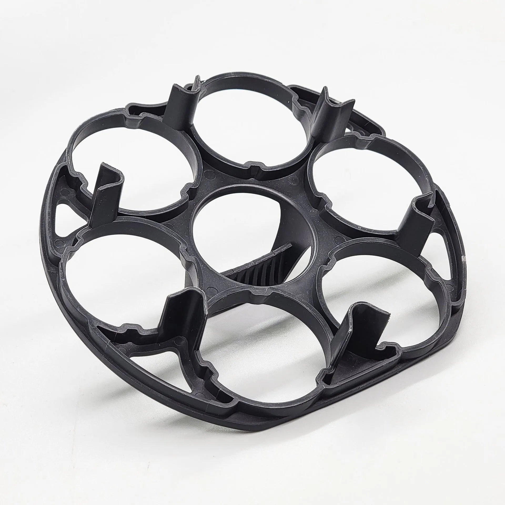 Black plastic egg holder cooking basket rack with retainer on a kitchen counter.