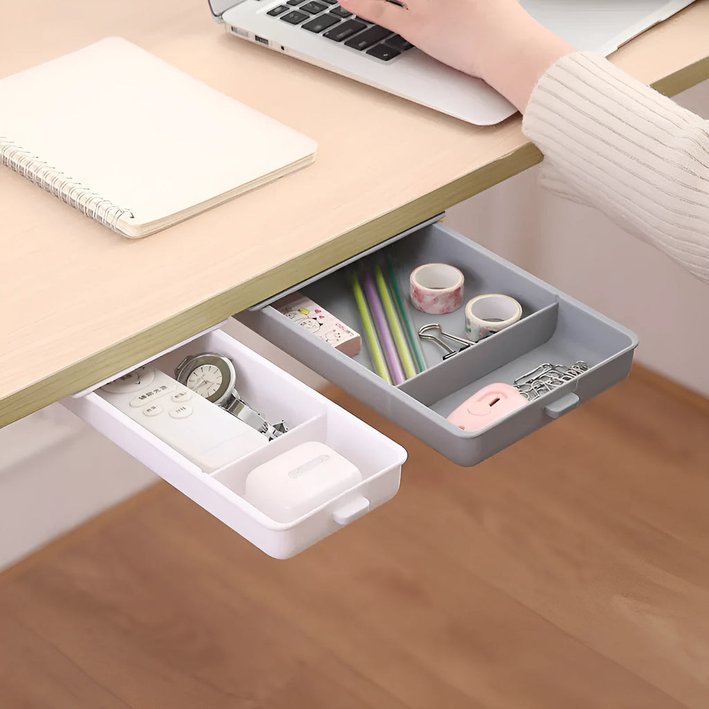 White plastic under-table storage drawer with magnetic adhesive backing and internal grid compartment