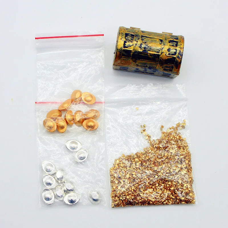 Miniature alloy gold coin and gold bar doll house accessory ornaments on display.
