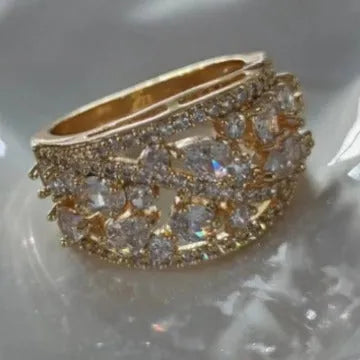 Women's round hollow fashion ring in gold and platinum colours with blue or white stone accents.