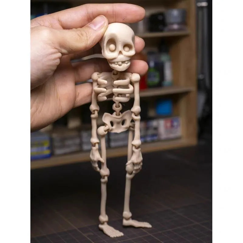 3D printed white skull Halloween fridge magnet, 18cm high, on a refrigerator door.