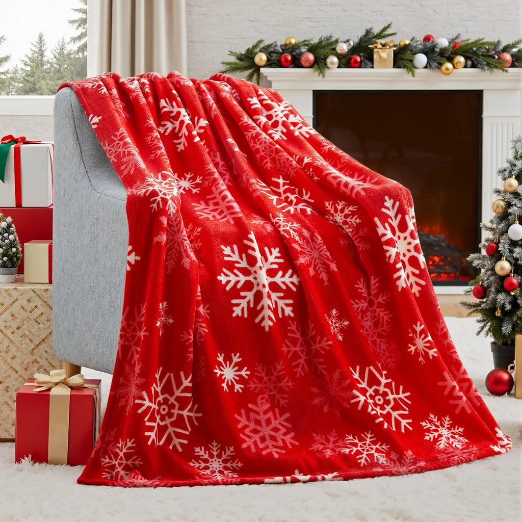 Soft red and green plush Christmas blanket draped over a sofa