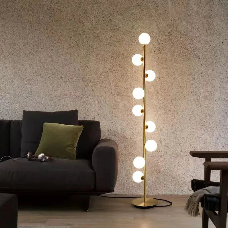Modern minimalist floor lamp with wrought iron frame and round marble base, showing four light colour options.