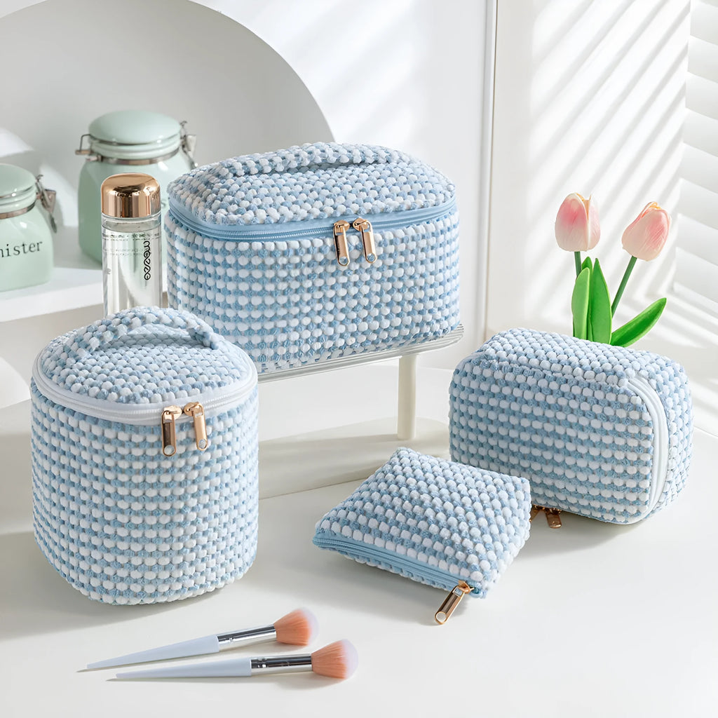 Set of four cube-shaped pink flannelette makeup bags with zips, one showing a removable interior divider and a metal hook.