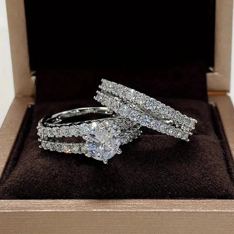 2 in 1 fully jewelled female fashion ring set in silver, gold, and rose gold on a geometric background.