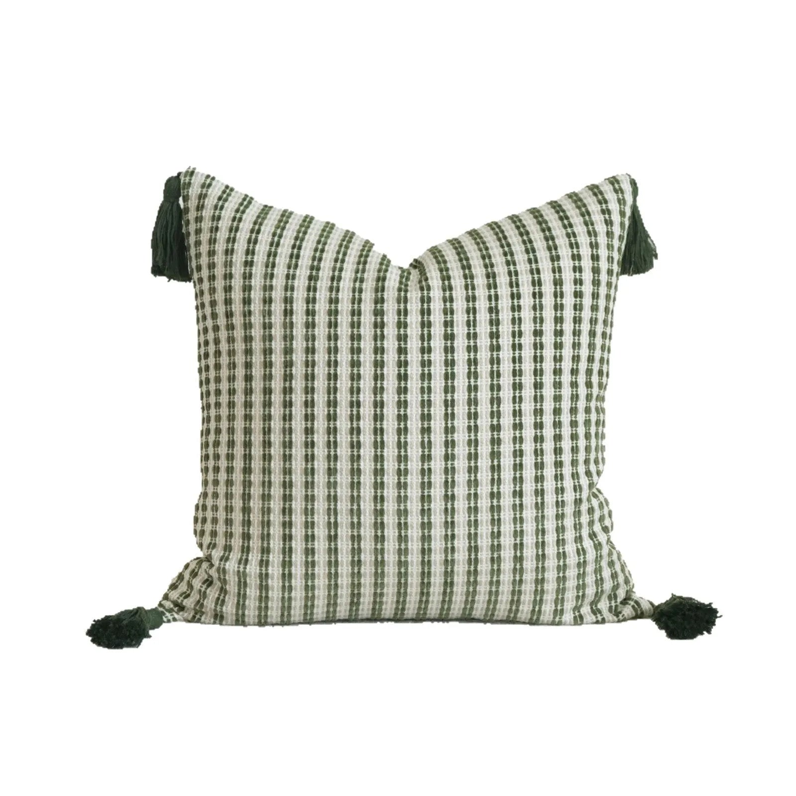 Green striped and botanical pattern decorative pillow with tassels on a bed.