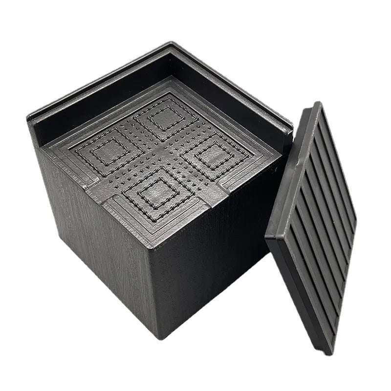 Four black plastic bed foot mats for increasing sofa or furniture height.