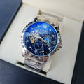 Silver case men's automatic watch with black dial, luminous hands, and brown leather strap.