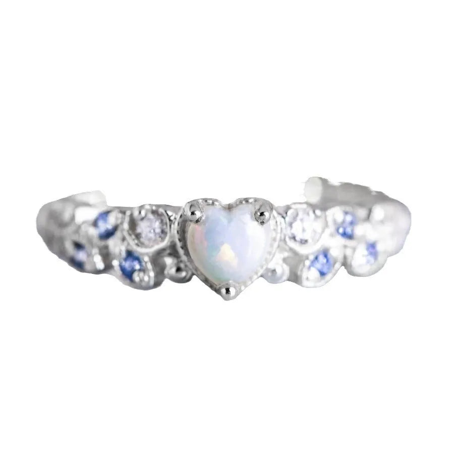 Silver-colour alloy ring with a peach heart centre and a floral opal stone detail.