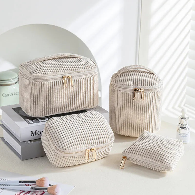 Set of four cube-shaped pink flannelette makeup bags with zips, one showing a removable interior divider and a metal hook.