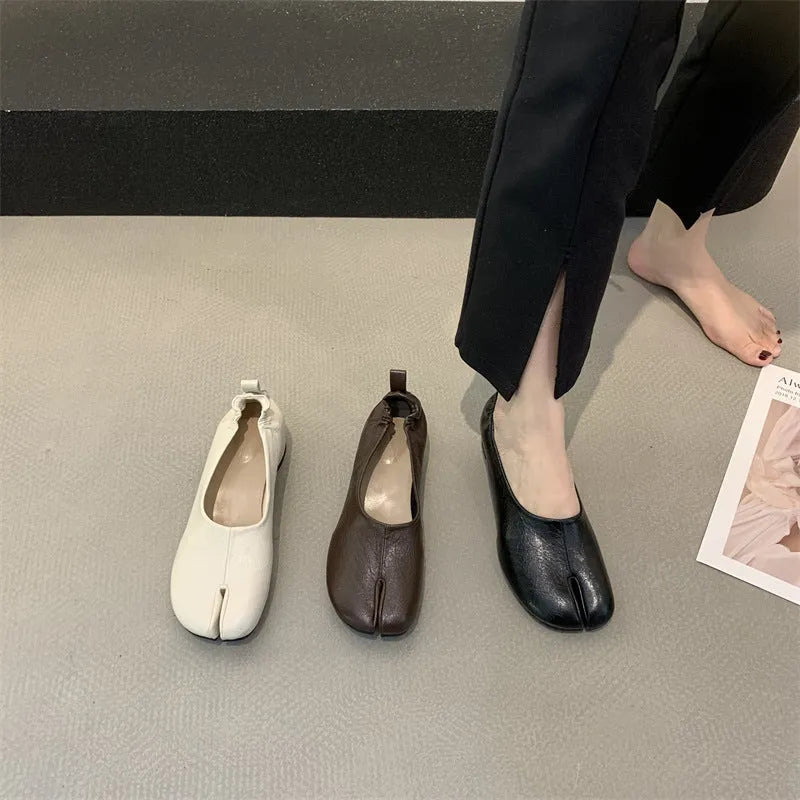 Women's round toe pumps with a split toe horseshoe design and a low chunky heel.