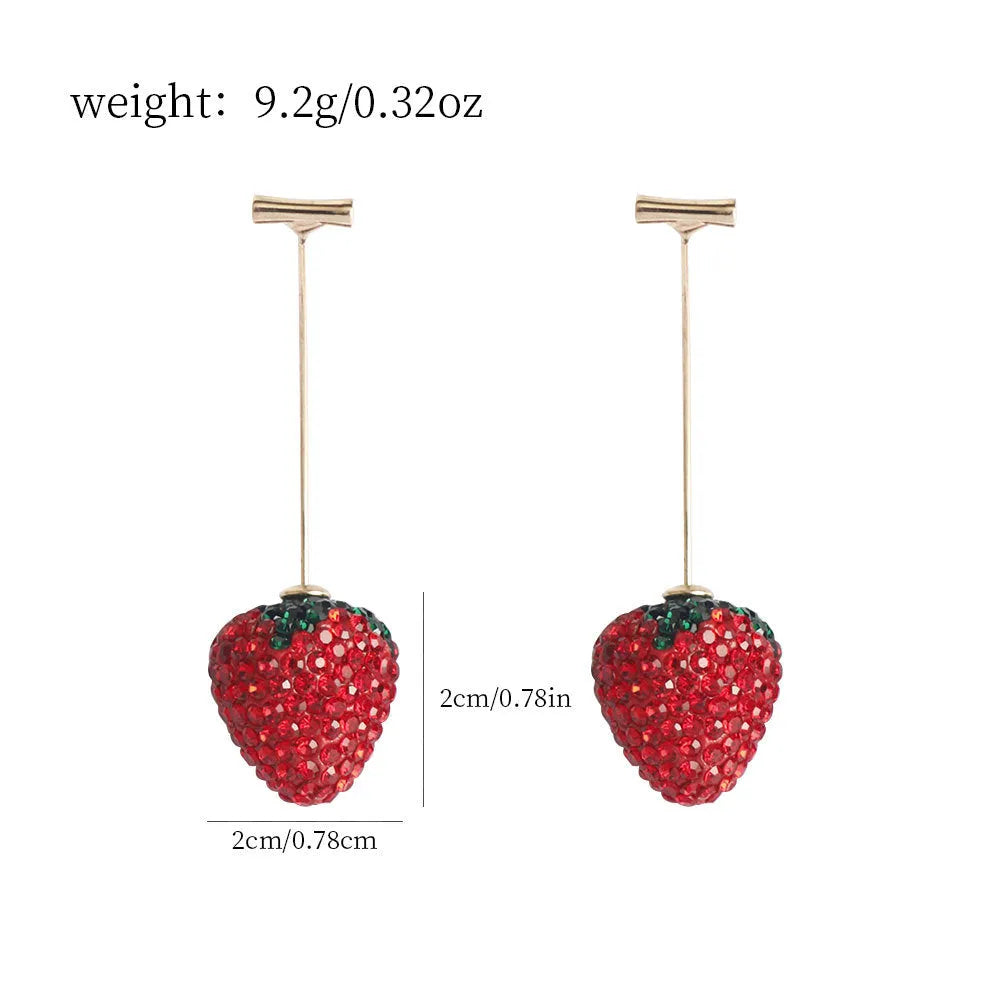 A pair of red geometric strawberry stud earrings with a faceted surface and butterfly clutch fastenings.