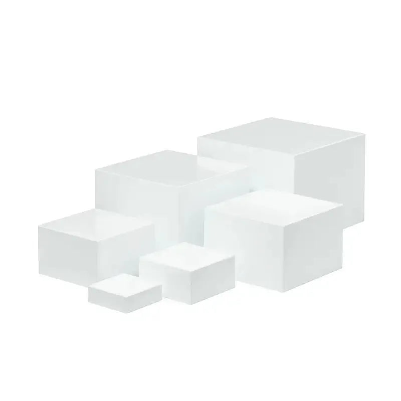 White plastic cube-shaped dessert display stand with multiple tiers for cupcakes and pastries.