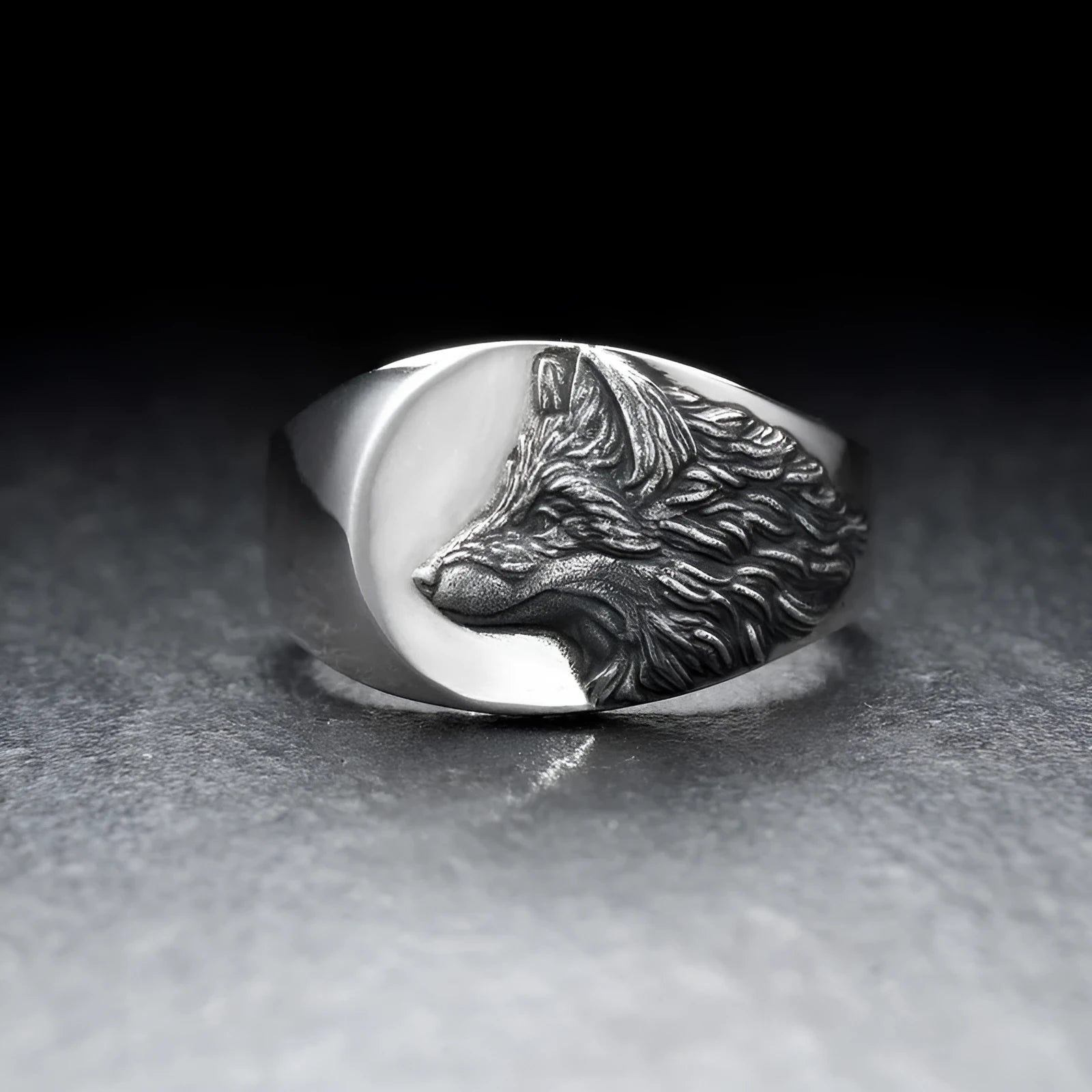 Silver alloy men's ring with a geometric wolf design on a black background.