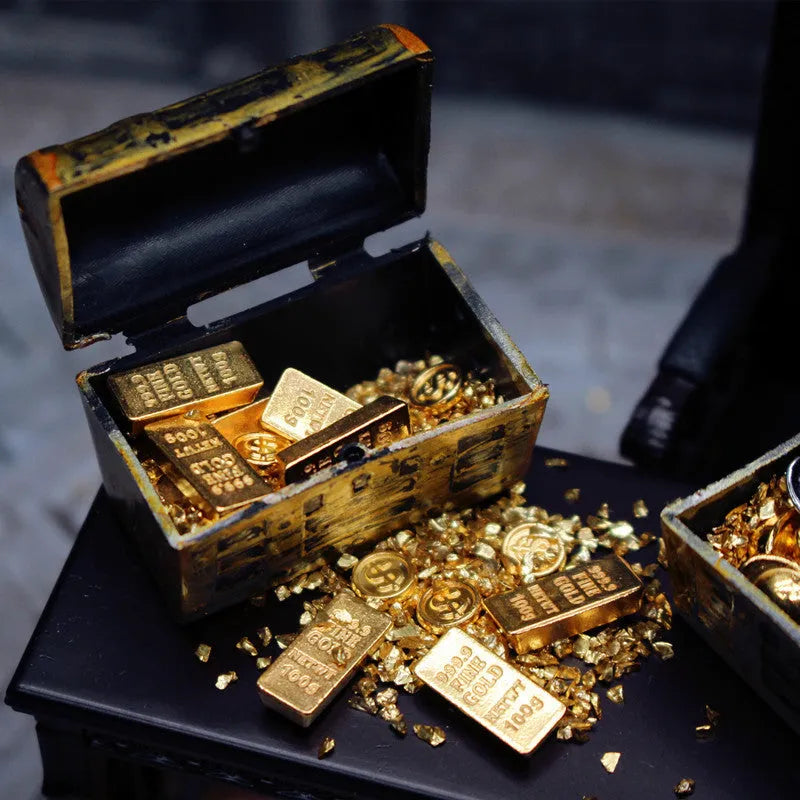 Miniature alloy gold coin and gold bar doll house accessory ornaments on display.