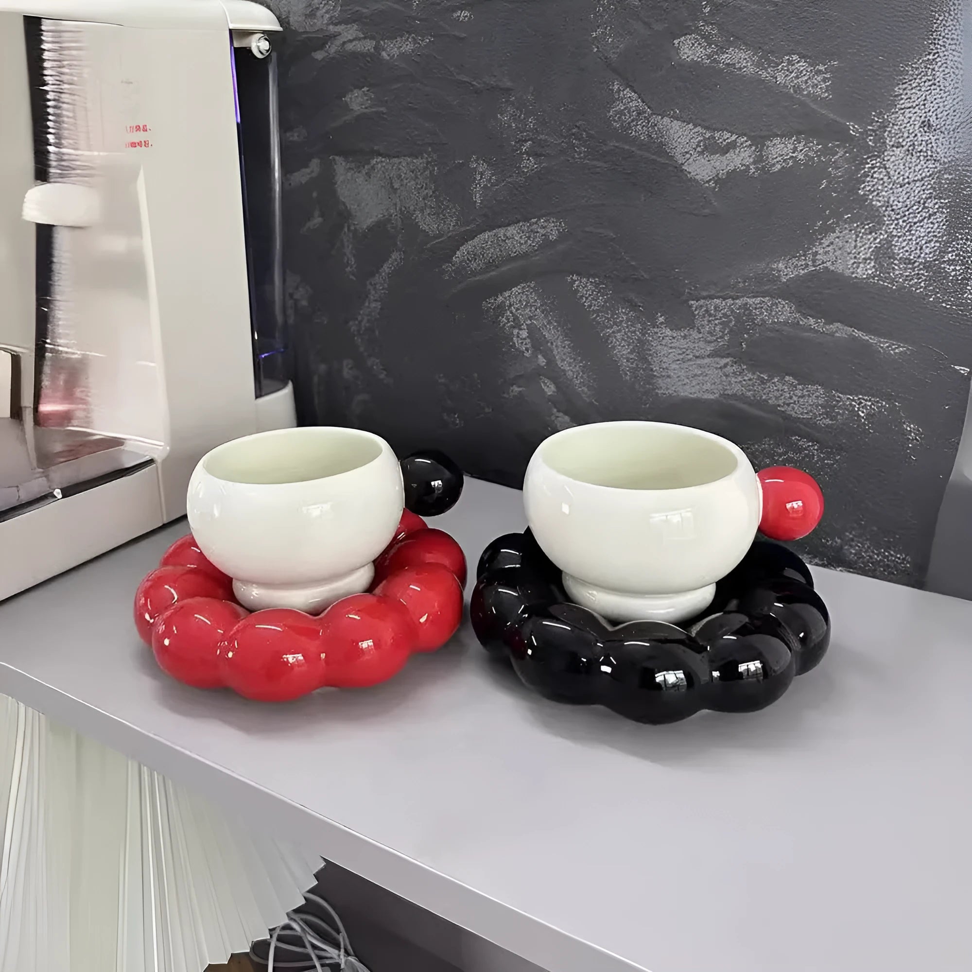 Ceramic coffee mug and saucer set in a solid colour on a table.